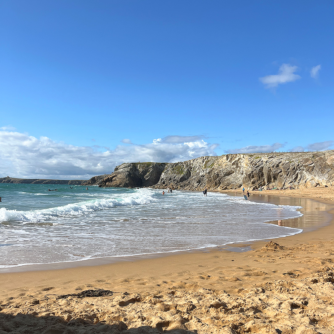 Bretagne mit Kindern - Südküste Bretagne mit Kindern. Hier zu sehen ein Strand an der wilden Küste mit hohen Wellen und umgeben von hohen Klippen.