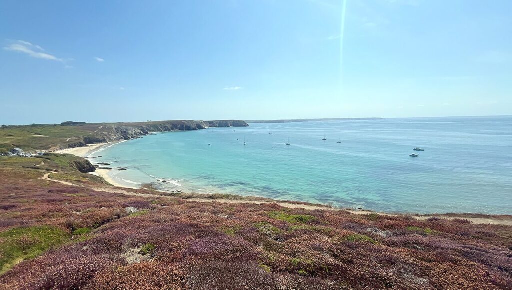 Eine schöne Bucht mit einem Strand und Heidekraut im Hintergrund. Es ist das Titelbild zum Artikel über den Westen der Bretagne. Das Bild wurde an der Presquile de Crozon aufgenommen.